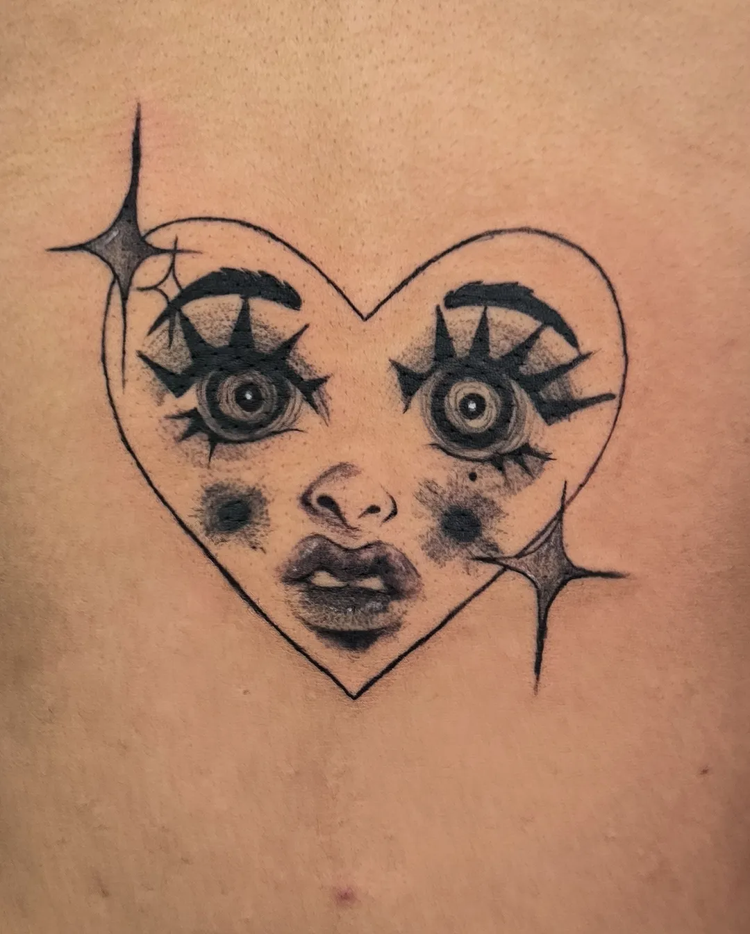 Illustrative heart with staring eyes tattoo by Kin, Blacklow Studio Bali