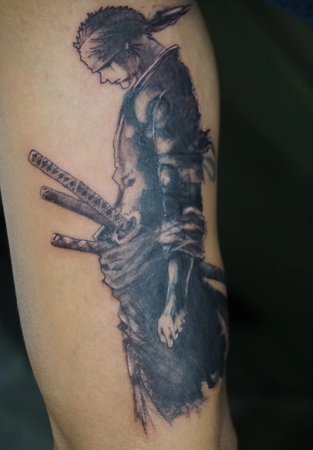Black-and-grey illustrative ronin samurai tattoo by Kin, Blacklow Studio Bali